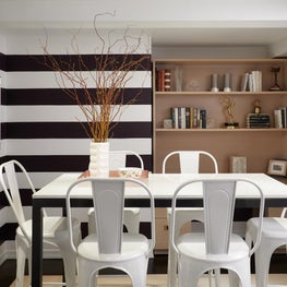 Upper East Side Breakfast Room with horizontal striped walls and metal chairs