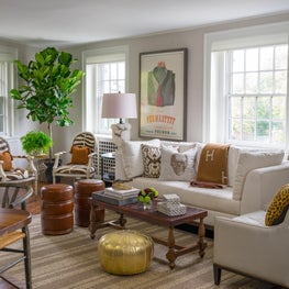 Sun Drenched Neutral Living Room with Gold Pouf and Fiddle Leaf Fig Tree
