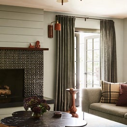 Living Room with Leather Sconce and Sculptural Marble Table