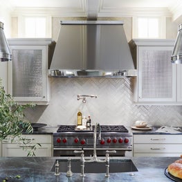 Kitchen with green marble countertop and metal accents
