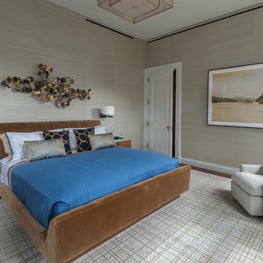 NYC Apartment Master Bedroom with patterned area rug and wallpaper, sculpture