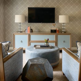 Bonus room with large club chairs and a cozy round ottoman