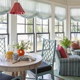 Lakefront home breakfast area in soft blue and pops of red