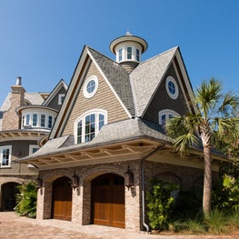 Shingle Style Carriage house with Arched Windows and Mahogany Garage Doors
