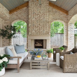 Equipped with a fireplace, outdoor kitchen, and plenty of seating, this covered loggia is the perfect, year-round entertaining space.