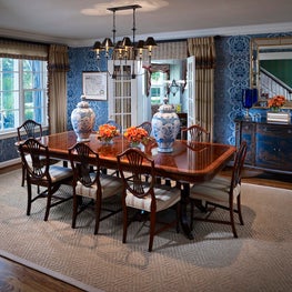 Wallpaper the walls with a bold design and add over scale dining table.
