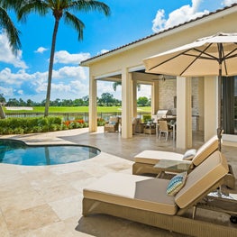 Expansive Decadent Waterfront, marble patio, marble pool, inground pool, lounge chairs, outdoor kitchen, outdoor den