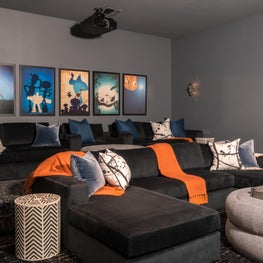 Portfolio: Fun and functional kid-friendly media room with movie posters and pops of color