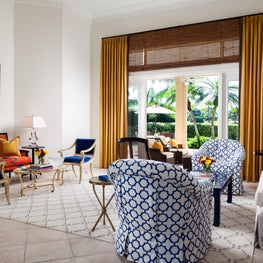 Adjacent to the terrace the living room has two colorful separate sitting areas.