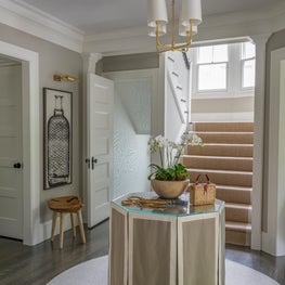 Neutral Foyer with Table Skirt, Wooden Stool and Brass Accents