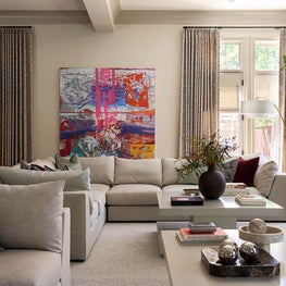 Portfolio: A tailored sectional surrounds sculptural coffee tables, expressive artwork, and thoughtfully styled accessories.