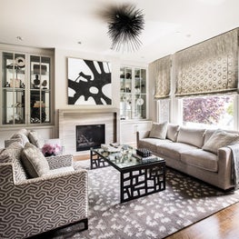 Living Room with gray walls, white oak floors, tonal fabrics with texture accented by bold touches.