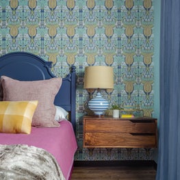 Arts and crafts Voysey wallpaper with floating nightstands and vintage headboard