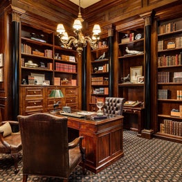 This traditional masculine dark wood library is now being used as a home offices well.