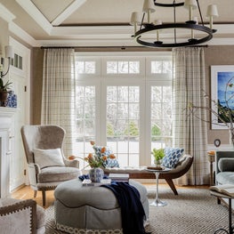 Neutral beige cream living room sunburst vaulted ceiling two-tier chandelier