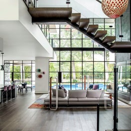 Portfolio: Mid-century modern foyer leading to an open living room with floor to ceiling windows