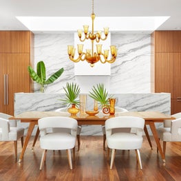 A dining area in front of a well-hidden kitchen. A double-tiered Murano chandelier hangs over a 1950's style table. Featured in Papercity.