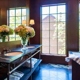 Master Bathroom with walnut walls, marble floors, and double washstand 