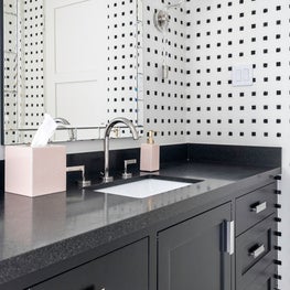 Portfolio: Sophisticated polka dot wallpaper and black cabinets in a powder bathroom.