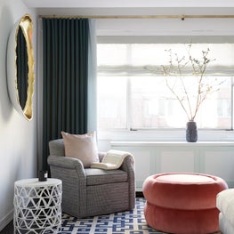Upper East Side Living Room with green drapery, geometric rug & gold egg mirror