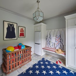 Lake Geneva Mud Room. Red, white & blue Mini-Cabana with orange industrial cart & framed vintage bathing suits.