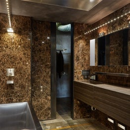 Marble walls, stainless soaking tub and floating vanity