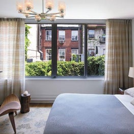 A modern and minimal bedroom calls for an airy light use of fabric.