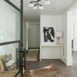 Entryway with Hide rug, Leather Chairs, and Custom Lighting