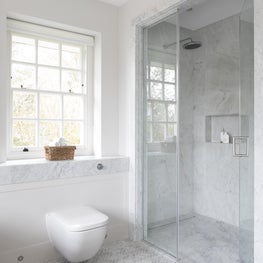 Luxury master bathroom with carrera herringbone flooring and shower 