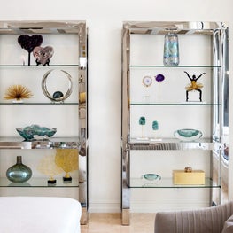 Expansive Decadent Waterfront, chrome shelves, freestanding shelves, art glass, collection display, neutral room