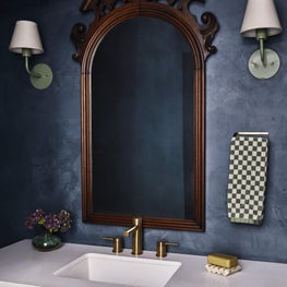 Blue Bathroom with Plaster on the Wall and Wood Antique Mirror