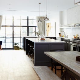 Manhattan industrial loft kitchen with floor to ceiling window and black accents