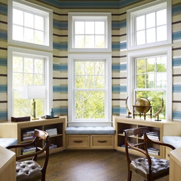 Octagonal double home office with horizontal stripe wallpaper and built-in benches
