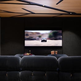 Cinema / family room - iconic furniture, bespoke bar , room wrapped in Blue tones