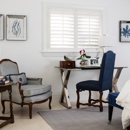  This inviting bedroom corner with a modern desk is used as a personal office.