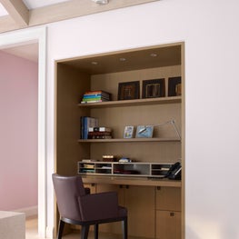 Home office with built-in desk, cabinetry and storage