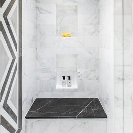 Luxurious Marble Shower with Built In Seating and Brass Accents