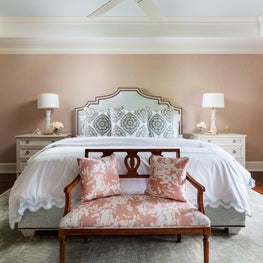 The backdrop of this master suite is a beautiful pale coral.