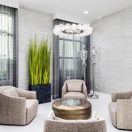 SLEEK CONTEMPORARY METALLIC RESIDENCE modern lounge, taupe club chairs, modern chandelier, tall house plants, tall sculptues, tall gray curtain sheers