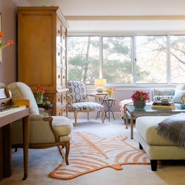Washington D.C. Great Room. Open plan living with lavender walls, orange striped tiger rug & french chairs.