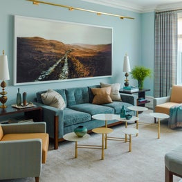 West End Living Room with blue velvet sofa and oversized landscape photograph