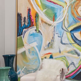 Large scale vibrant abstract art, acrylic chair and faux fur throw.