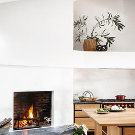 Soulful Home Kitchen with Fireplace and Garde Hvalsøe Copenhagen-made cabinets