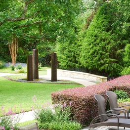 A garden adjacent to the mail house in a North Dallas neighborhood featured interesting sculpture and landscaping.