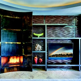 The entire fireplace wall adds texture and style to this minimalist setting