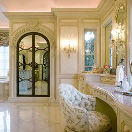 The shower door, positioned between the tub and vanity, is actually constructed of two-way mirrored panels.  Light streams in through the windows, which can be concealed with mirrored shutters that slide from within the walls.