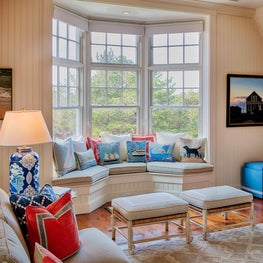 Cozy banquette seating is decorated with whimsical marine themed accent pillows.