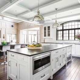 White kitchen coffered ceiling arched metal window table island with turned legs