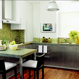 Green and white NYC apartment kitchen, mosaic tile backsplash