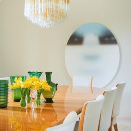 A large dining room in a modern house that can seat fourteen people.